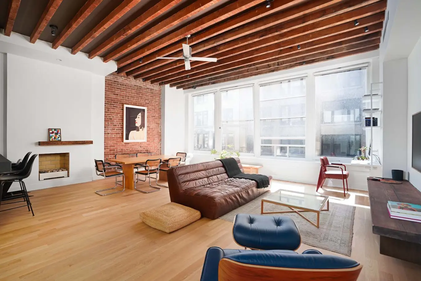 Loft living room with timber beams and oversized windows